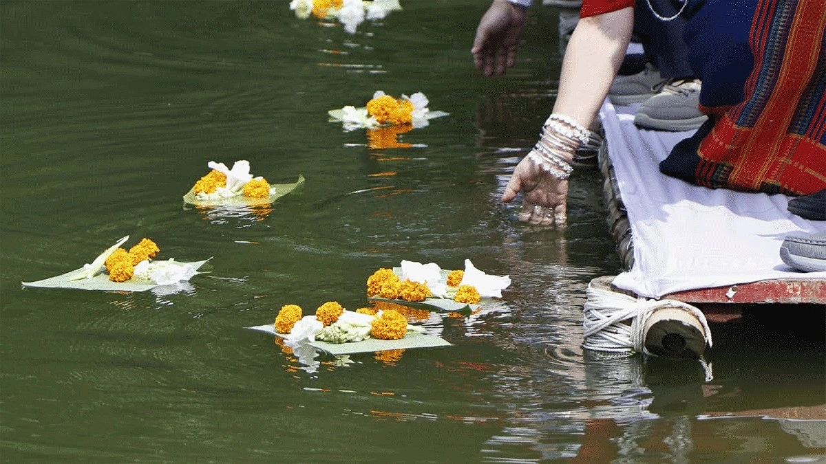 লেকের পানিতে ফুল ভাসাচ্ছেন নারীরা